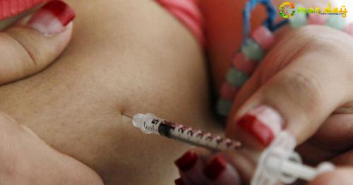 A teenager diagnosed with diabetes giving herself an injection of insulin. AP file photo