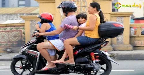 A man and his family rides on a motorcycle along a main street in Tondo, metro Manila, Philippines on September 1, 2017. 