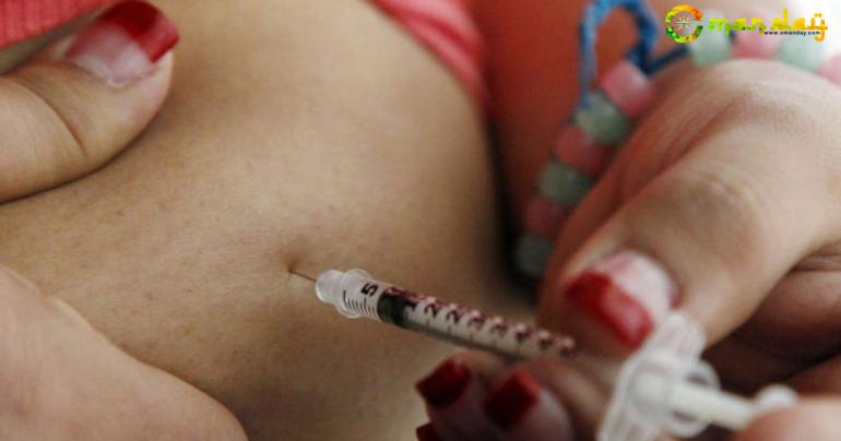 A teenager diagnosed with diabetes giving herself an injection of insulin. AP file photo