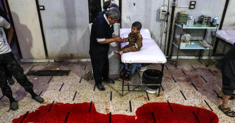 RIVER OF BLOOD Terrified baby cries in blood-soaked hospital after Syria airstrike kills eight civilians